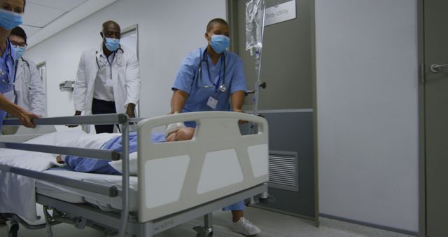 Medical professionals including doctors and nurses are moving a patient on a stretcher bed through a hospital corridor, emphasizing teamwork and urgent medical care. Useful for illustrating healthcare teamwork, hospital emergency, patient care, and medical environments in marketing, editorials, and healthcare-related materials.