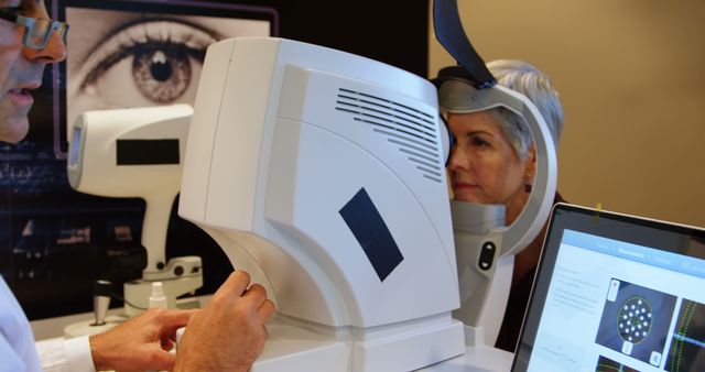 Optometrist performing a detailed eye examination on a senior woman using advanced medical equipment. This is suitable for illustrating healthcare advances, ophthalmology practices, vision care, and senior health. It can be used in medical and healthcare articles, eye care professional biographies, technology in health features, and patient education materials.