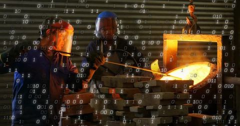 Foundry workers pouring molten metal in industrial setting