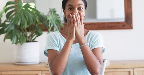 Woman Expressing Joy in Bright Living Room During Video Call - Download Free Stock Images Pikwizard.com