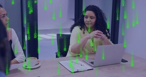 Businesswoman typing at laptop with green binary code overlay representing cybersecurity