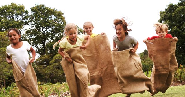 Diverse Children Excitedly Participating in a Sack Race Outdoors - Download Free Stock Images Pikwizard.com