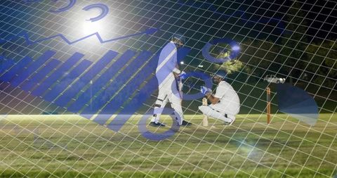 Night cricket players batting and wicketkeeping with data grid overlay for analytics