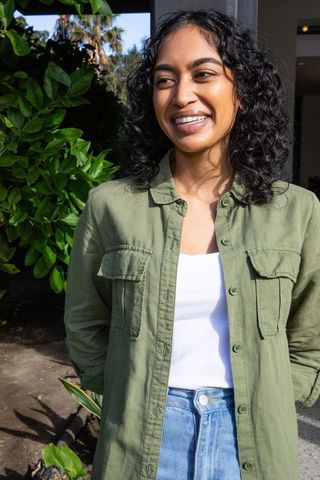 Casual woman relaxing outdoors in front of her home entrance