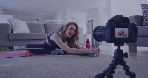 Fitness influencer recording workout vlog at home