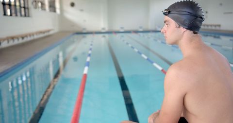Male swimmer contemplating before diving, photo with positive energy