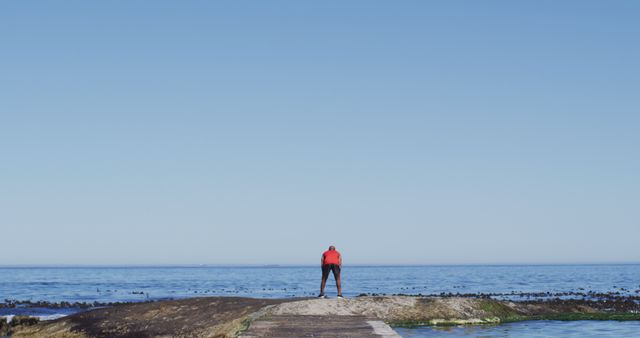 Man in Red Jacket Looking Out at Ocean - Download Free Stock Images Pikwizard.com