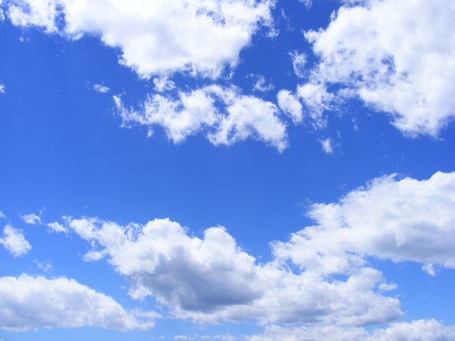 Blue sky scattered with fluffy white clouds creates a serene and tranquil feel. Perfect for backgrounds, nature-related promotions, weather forecasts, website banners, and visual relaxation purposes.