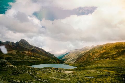 Scenic View of Serene Lake with Mountain Background at Sunset