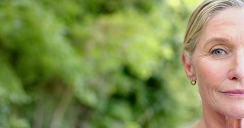 Middle-Aged Woman with Blonde Hair Gazing Calmly Outdoors - Download Free Stock Images Pikwizard.com