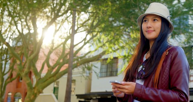 Young Woman Exploring City with Smartphone on a Sunny Day - Download Free Stock Images Pikwizard.com