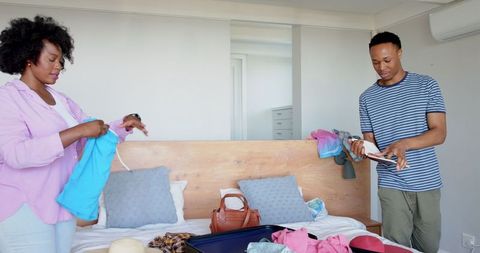 Couple planning vacation unpacking luggage for adventure