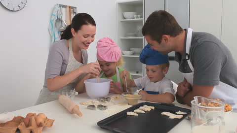 Family Enjoying Baking Together in Modern Kitchen