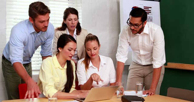 Diverse Business Team Collaborating on Laptop in Meeting Room - Download Free Stock Images Pikwizard.com