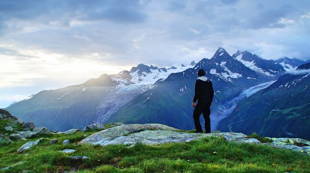 Man Hiking and Admiring Snow-Capped Mountain Scenery at Sunrise - Download Free Stock Photos Pikwizard.com