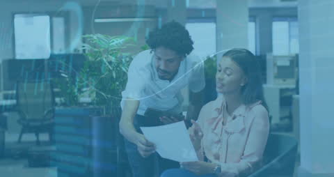 Colleagues Analyzing Statistical Data in Modern Office