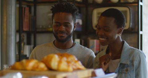 Happy Couple Choosing Pastries in Relaxing Bakery Environment