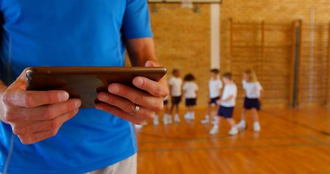 Coach Using Tablet for School Basketball Training