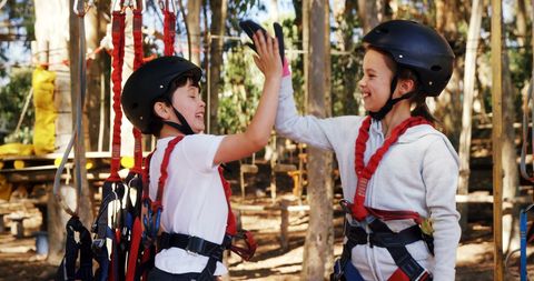 Children Celebrating Success at Outdoor Adventure Park