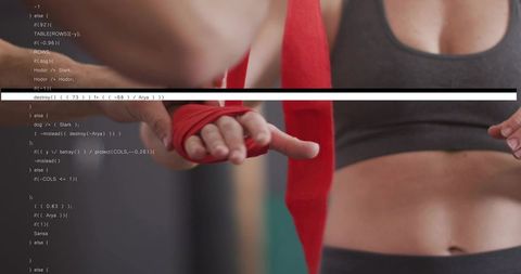 Trainer wrapping female boxer hands with red handwraps closeup showing torso
