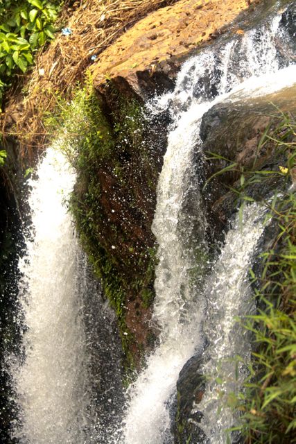 Cascading Waterfalls between Rocks with Greenery - Download Free Stock Photos Pikwizard.com