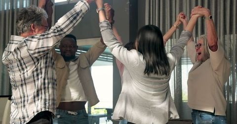 Diverse Group Celebrating Happiness in Therapy Session