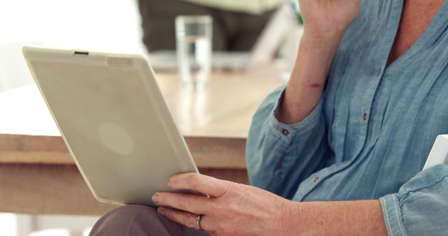 Senior Woman Reading on Tablet While Drinking Coffee - Download Free Stock Images Pikwizard.com