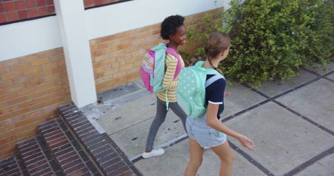 Students Walking to School with Colorful Backpacks