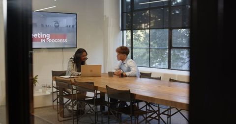 Diverse professionals in meeting collaborating on strategy