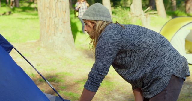 Woman Setting Up Tent at Campsite in Forest - Download Free Stock Images Pikwizard.com