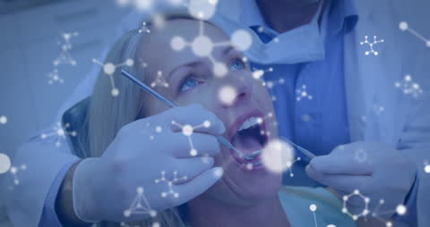 Dentist Examining Female Patient with Molecular Structure Overlay