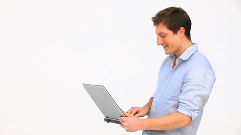 Young Professional Man Using Laptop in Studio Setting