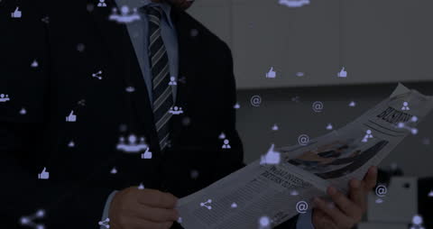 Businessman Reading Newspaper Amidst Digital Networking Icons