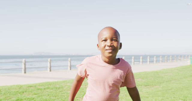 Smiling Boy Enjoying Outdoor Playtime Near Beach - Download Free Stock Images Pikwizard.com