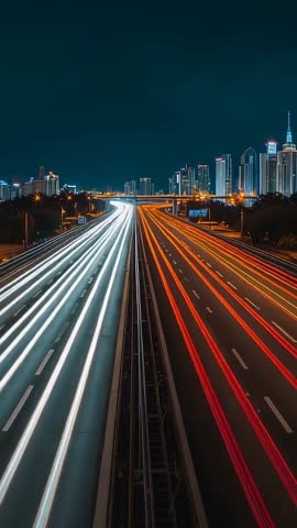 Streaming Light Trails Racing Toward Downtown Skyline on Multilane Highway Vertical Night Video