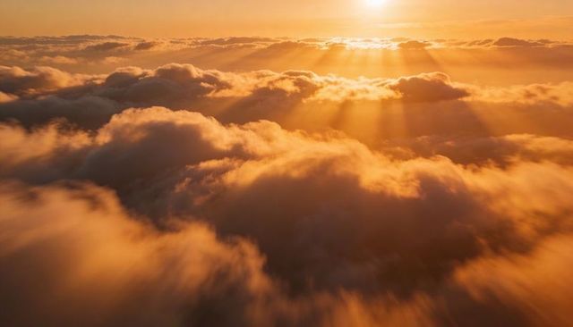 Sunlight streaming across layered stratocumulus at golden sunrise with radiant sunbeams