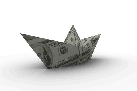 Transparent origami boat folded from hundred dollar bill