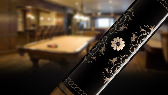 Detailed billiard cue with intricate designs in elegant pool hall. Ideal for use in advertising cues, promoting luxury pool halls, and adding sophistication to content related to billiards or leisure activities.