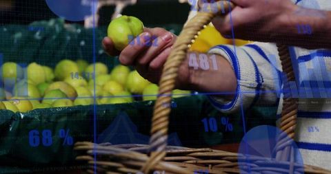 Person selecting green apples with digital data overlays