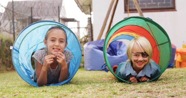 Children Playing in Tubes with Pirate Costume Outdoors - Download Free Stock Images Pikwizard.com