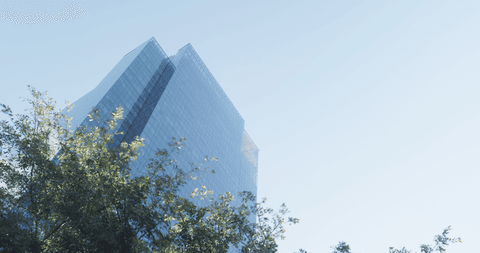 Transparent Modern High-rise Tower Against Clear Blue Sky - Download Free Stock Videos Pikwizard.com