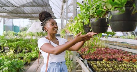 African American Woman Enjoying Time at a Greenhouse Nursery