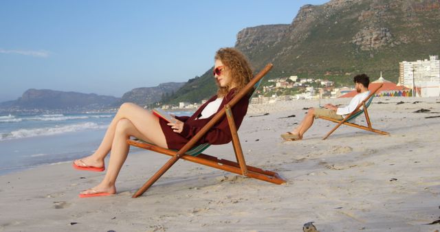 Relaxed Couple Enjoying Beach in Deck Chairs with Scenic Mountain View - Download Free Stock Images Pikwizard.com