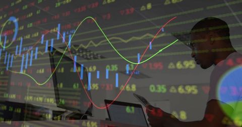 Business professional analyzing digital market trends on laptop tablet dual screen