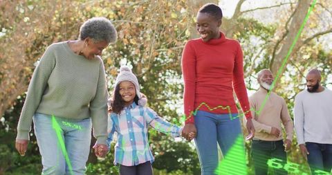 Multigenerational African American Family Walking Hand-in-Hand Through Sunlit Autumn Park