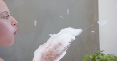 Close-Up of Woman Blowing Soap Bubbles Creating Whimsy
