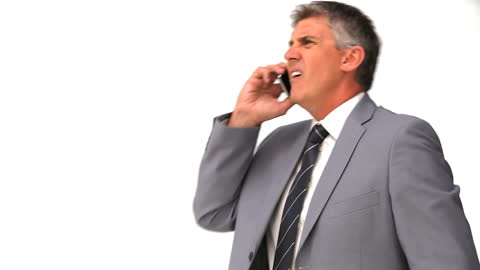 Elderly Businessman Resolving Issues Over Phone in Formal Suit