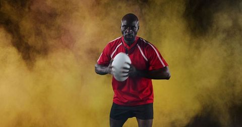 Determined Rugby Player Holding Ball Against Intense Backdrop