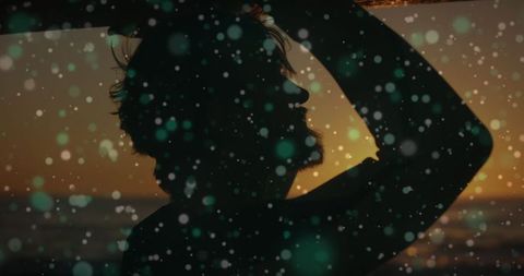 Silhouette of Man at Beach Contemplating Digital Interface