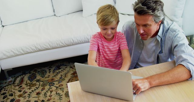 Father and Son Using Laptop in Living Room, Quality Family Time - Download Free Stock Images Pikwizard.com